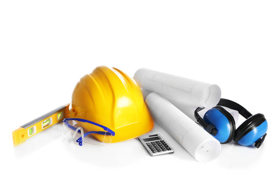 Construction drawings with tools and helmet isolated on white