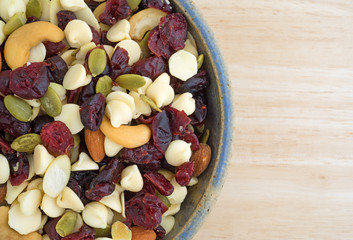 Nuts and fruit trail mix in a bowl on a table