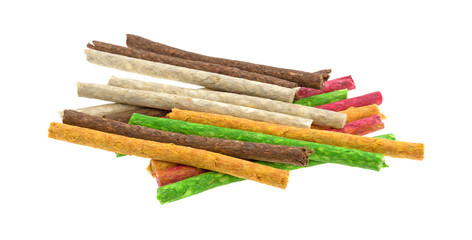 Group of beef hide dyed dog snacks isolated on a white background.
