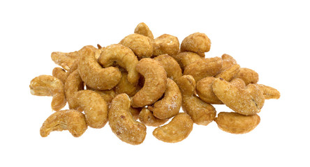 Whole honey roasted cashews on a white background