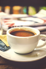 coffee cup on table, over light and vintage tone  [blur and select focus background]