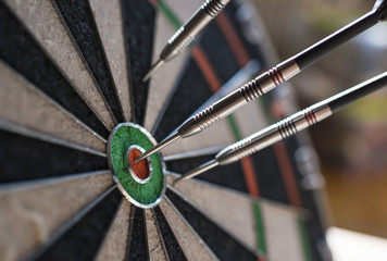 Darts sticking in a dartboard
