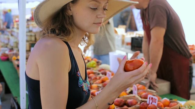 Young woman shopping at the local Farmers market