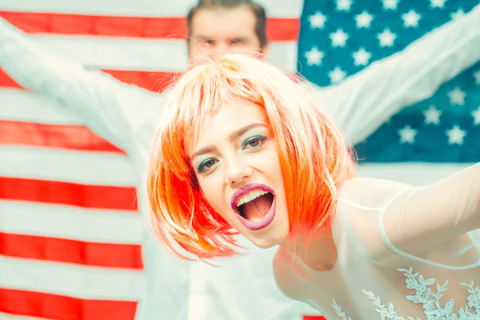 Happy young patriotic Americans bright make up and hair celebrating Independence Day on 4th of July - Powered by Adobe