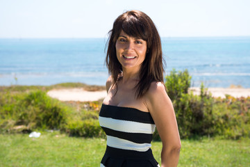 Beautiful woman posing in a park in from the beach