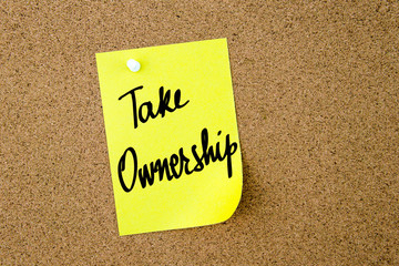 Take Ownership written on yellow paper note