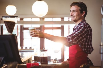 Waiter offering a cup of coffee