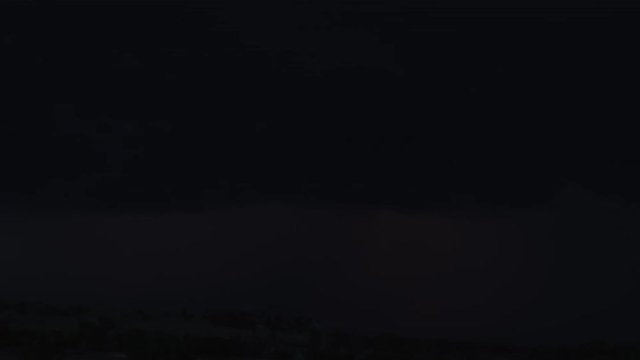 Night thunderstorm over low hills, time lapse