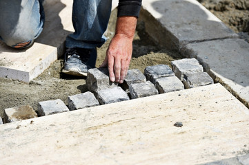 Mason working with cobblestone