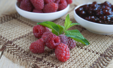 Raspberries and raspberry jam on a beige background