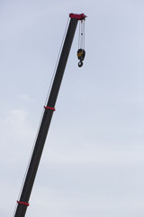 metal hook of a crane against the sky