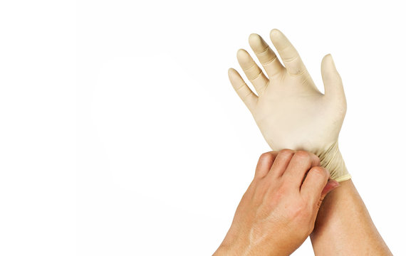 Gesture to wear rubber gloves to protect chemicals.