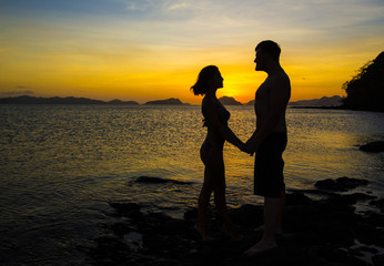 Silhouettes loving couple at sunset on the Philippine Islands