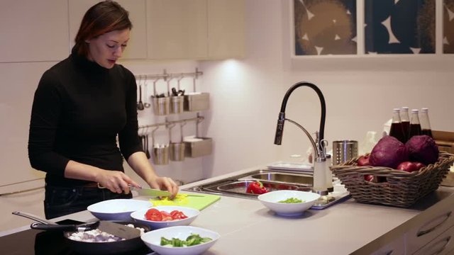 Woman Cuts Yellow Peppers for Salad