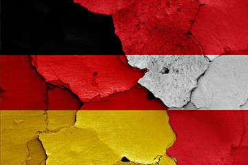 flags of Germany and Austria painted on cracked wall