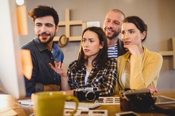 Team of graphic designers working on a computer