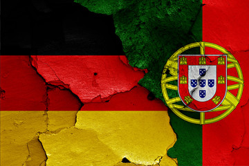 flags of Germany and Portugal painted on cracked wall