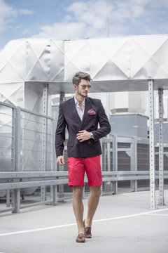 Handsome man in the jacket on a city background