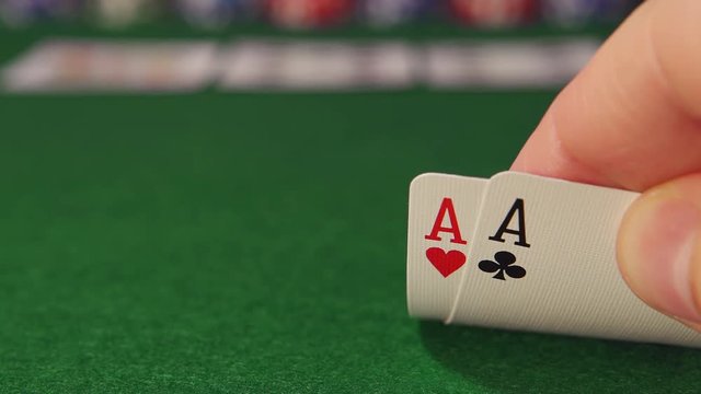 POKER: Player opens and looks playing cards in the game