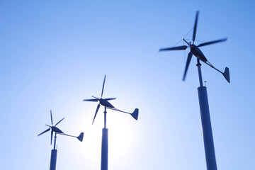 Energy wind turbines on clear blue sky