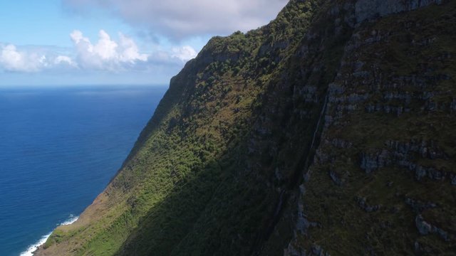 Past coastal cliffs and over forested hills on Molokai. Shot in 2010.