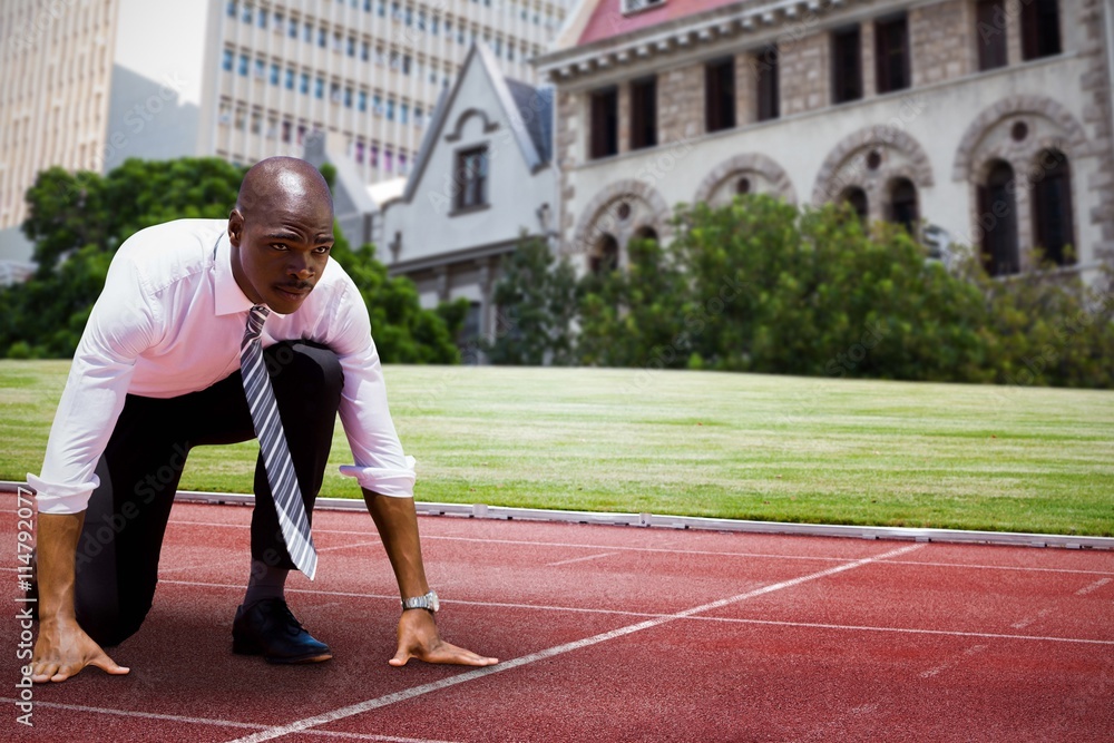 Poster composite image of close up of businessman in starting blocks