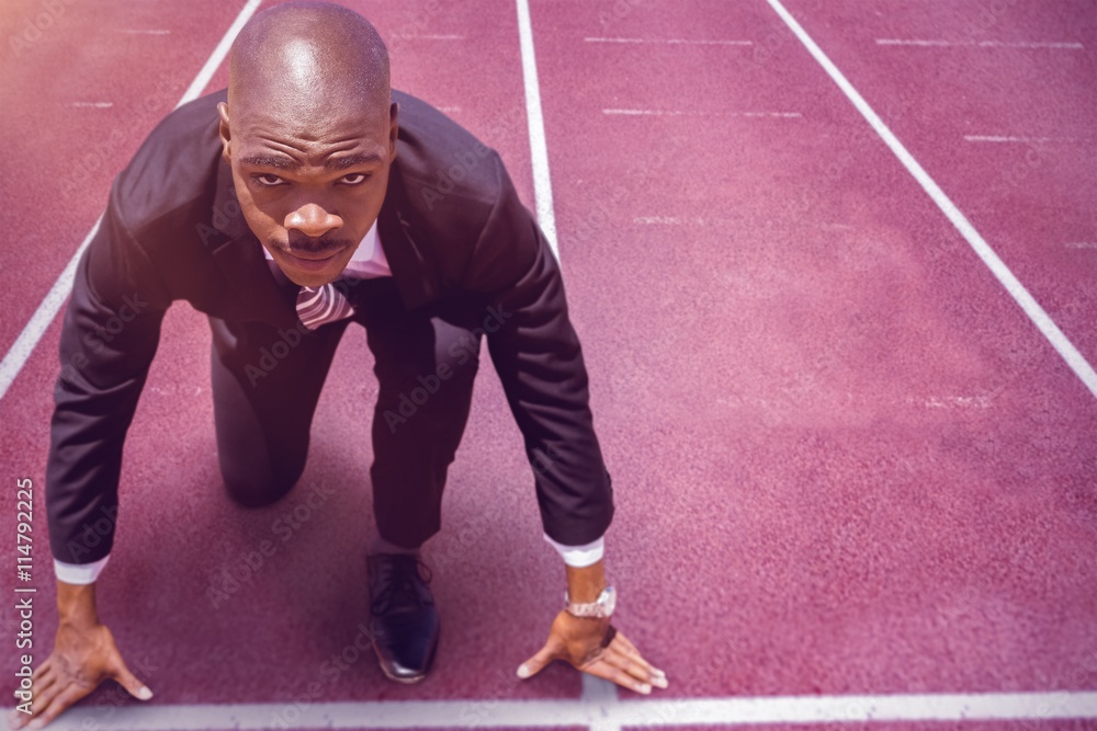 Poster composite image of close up of businessman in starting blocks