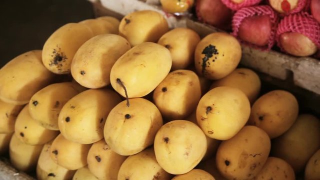 Selling yellow mango on fruit market, Philippines.Mango fruit on a tray sold on the market.Asian market