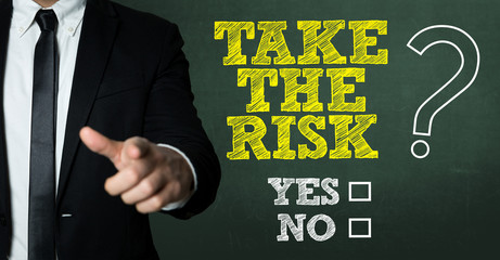 Business man pointing with the text: Take the Risk? Yes or No