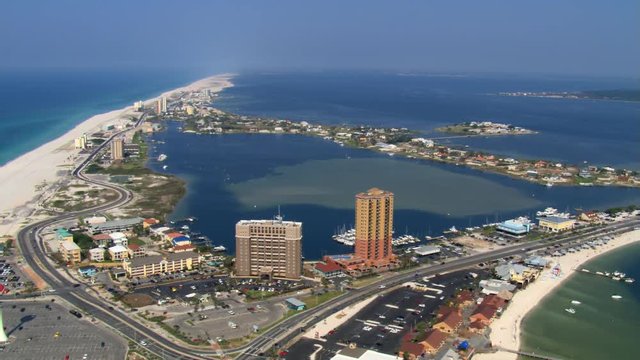 Wide aerial orbit of Pensacola Beach, Florida including beach. Shot in 2007.