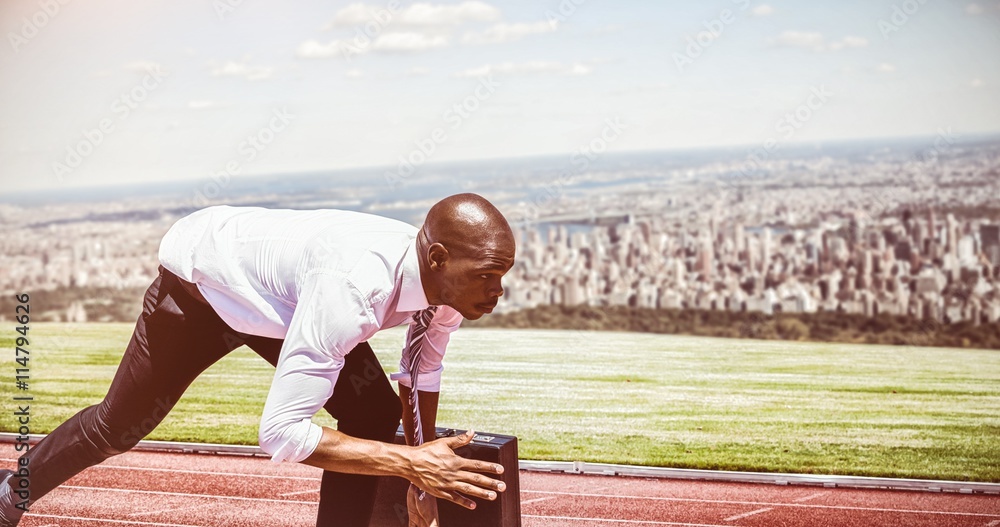 Poster composite image of close up of businessman in starting blocks