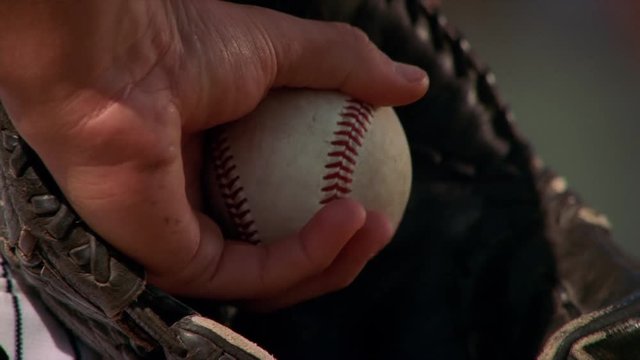 Close-up of ball in glove of left-handed pitcher