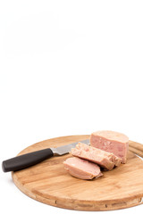 Luncheon meat on the wooden board isolated on white background