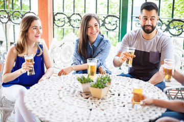 Group of friends having a conversation and drinking