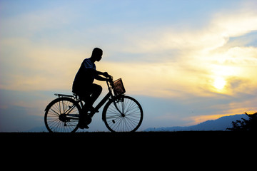 children enjoy ride bicycle during sunset.