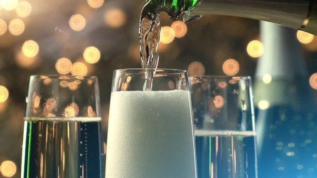 Champagne slow motion pour at night with Christmas lights and flares. 