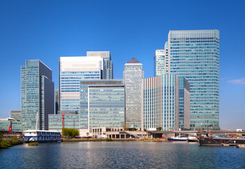 Fototapeta na wymiar London UK- May 21, 2015: Office buildings of Canary Wharf, international business and banking aria. View from the dock
