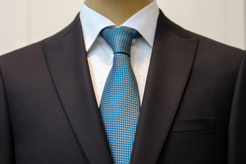 Black business suit with a white shirt and with a blue tie in drawing