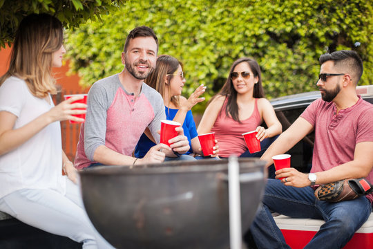 Young man at a barbecue with his friends