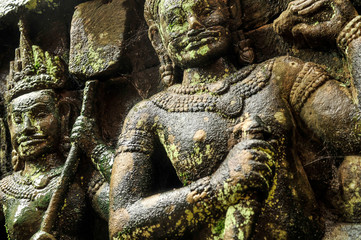 Carved bas relief designs on a temple at Angkor in Cambodia