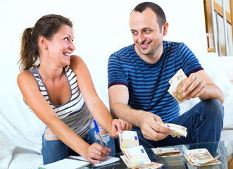 Fototapeta premium wife asking smiling man money for shopping