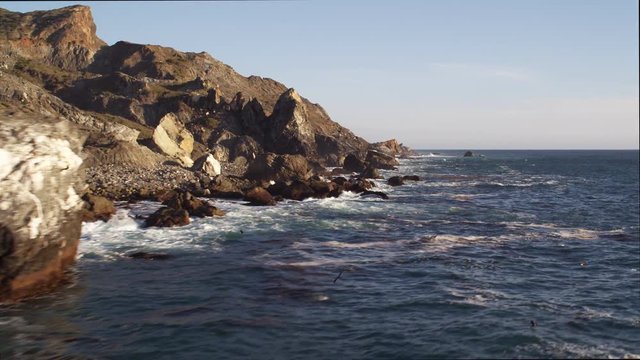 Close flight past rock formations along the Catalina coast. Shot in 2010.