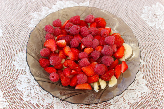 Sliced fruit and berries on a plate