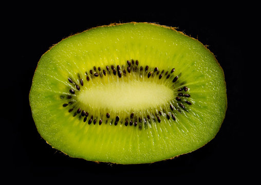 slice of kiwi on black background