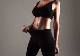 Athlete showing her slim stomach
