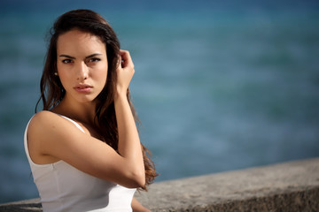 Beautiful young woman outdoors portrait near the sea