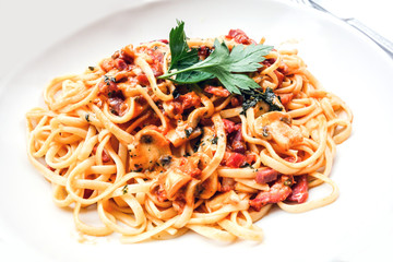 close-up of plate of pasta and chicken with lettuce
