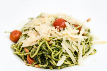 Pasta with pesto sauce and nuts on a the table