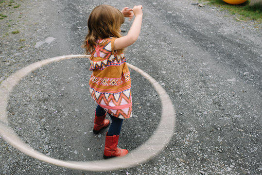 Girl playing with plastic hoop