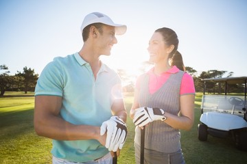 Cheerful golf player couple 